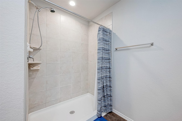 bathroom featuring hardwood / wood-style floors and walk in shower