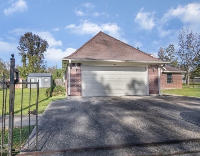 view of home's exterior with a shed, a garage, and a lawn