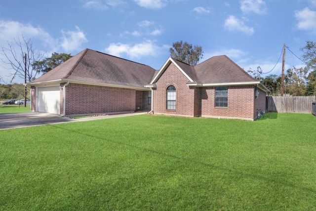 view of front of home with a front yard and a garage