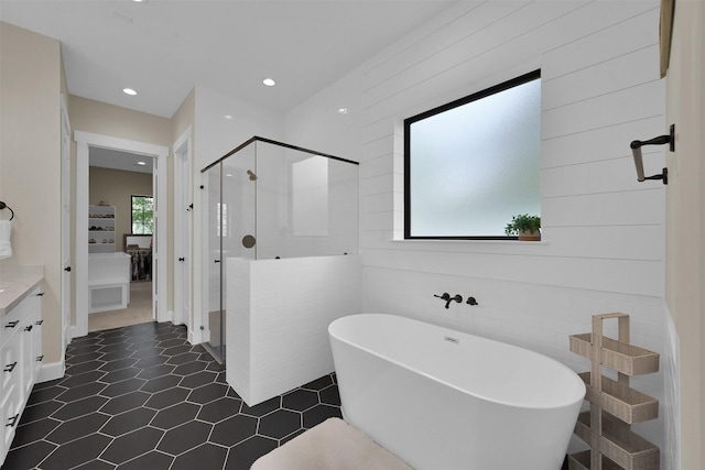 bathroom with tile patterned flooring, vanity, and separate shower and tub