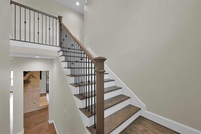 stairway with hardwood / wood-style floors