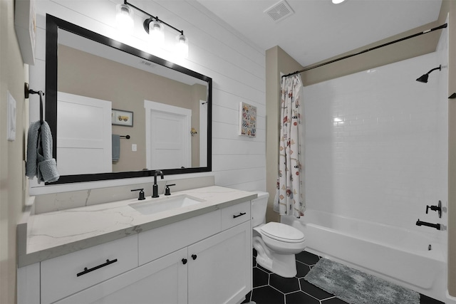 full bathroom featuring tile patterned flooring, wood walls, shower / bath combination with curtain, toilet, and vanity