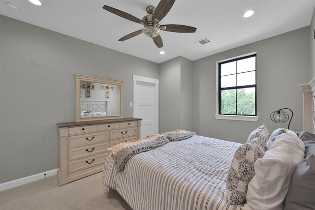 bedroom featuring light colored carpet and ceiling fan