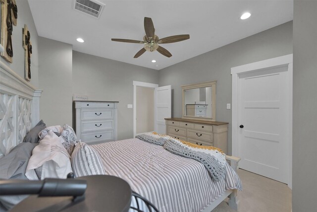 bedroom with ceiling fan and light colored carpet