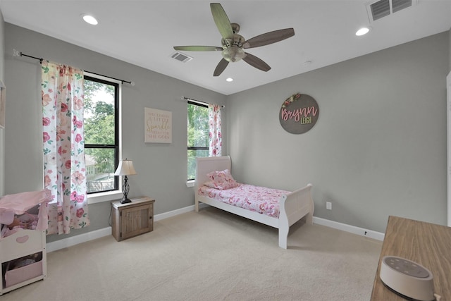 carpeted bedroom with multiple windows and ceiling fan