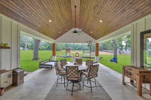 view of patio featuring ceiling fan, a trampoline, and a playground