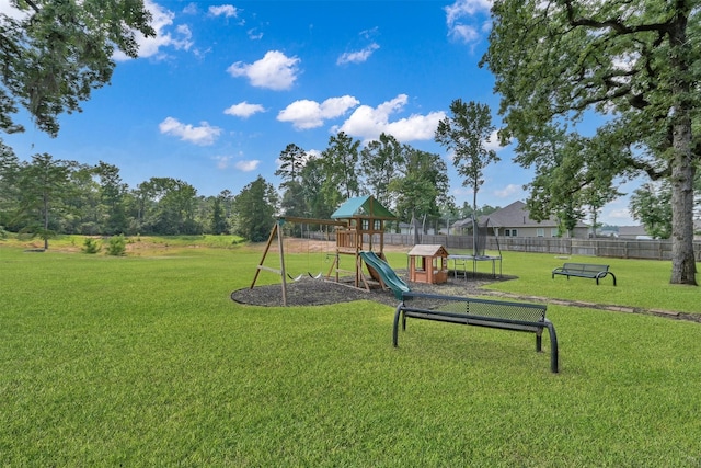 view of play area featuring a lawn and a trampoline