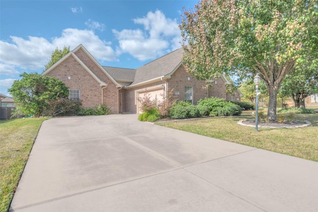 view of front of home with a front yard and a garage