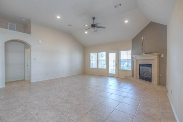 unfurnished living room with light tile patterned floors, a high end fireplace, ceiling fan, and vaulted ceiling