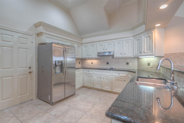 kitchen with sink, light tile patterned floors, white cabinetry, stainless steel fridge with ice dispenser, and decorative backsplash