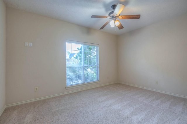 carpeted empty room with ceiling fan