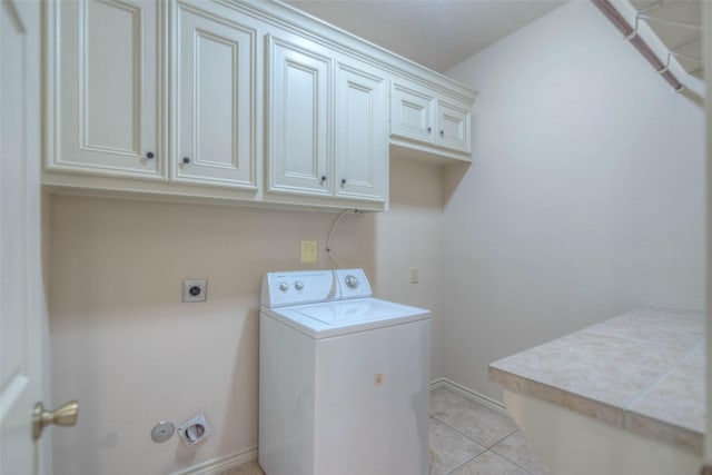 laundry room with cabinets, washer / dryer, and light tile patterned floors