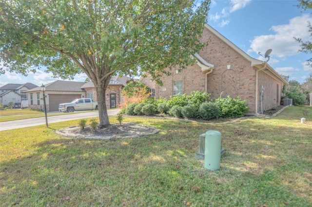 view of front of home featuring a garage and a front yard