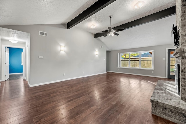 unfurnished living room featuring ceiling fan, lofted ceiling with beams, dark hardwood / wood-style floors, a textured ceiling, and a fireplace