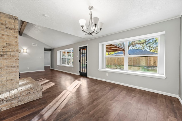 unfurnished living room with lofted ceiling with beams, dark hardwood / wood-style floors, and a healthy amount of sunlight