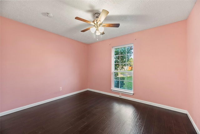 empty room with dark hardwood / wood-style floors, ceiling fan, and a textured ceiling