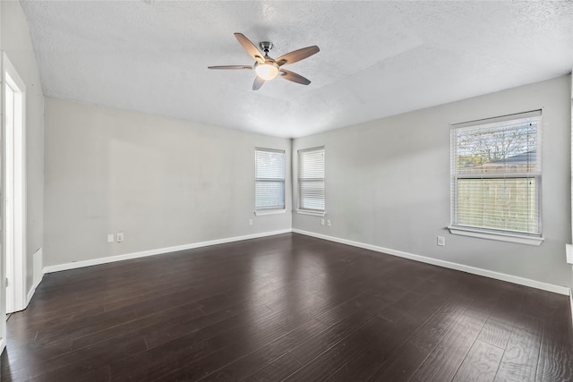 empty room with a textured ceiling, ceiling fan, and dark wood-type flooring