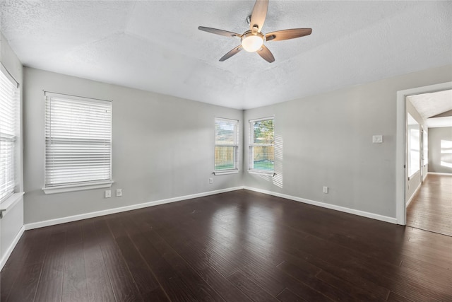 unfurnished room with a textured ceiling, ceiling fan, and dark wood-type flooring