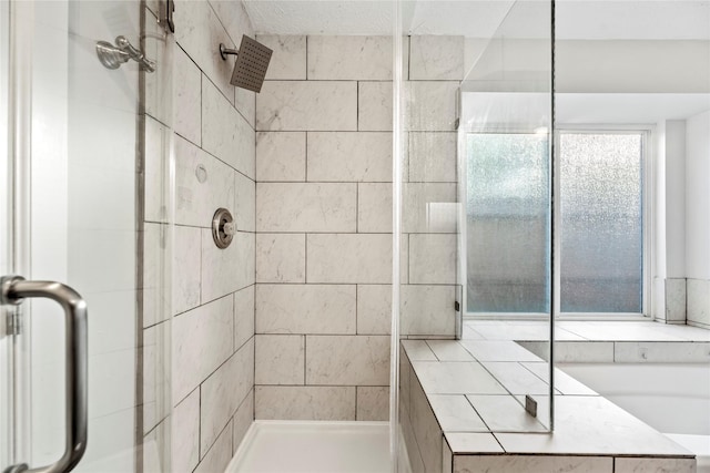 bathroom featuring a shower with shower door