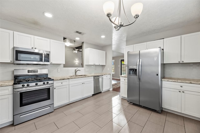 kitchen with pendant lighting, white cabinets, and stainless steel appliances