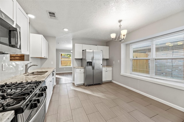 kitchen featuring white cabinets and appliances with stainless steel finishes