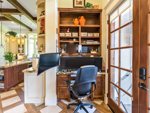 home office featuring beam ceiling, built in desk, crown molding, and light parquet flooring