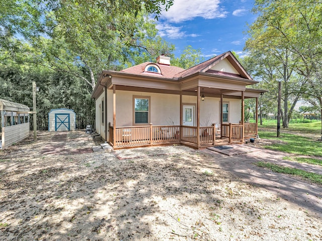 view of front facade with a porch and a storage unit