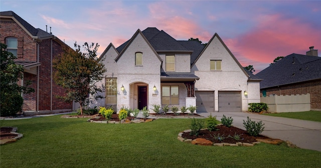 view of front of house with a garage and a lawn