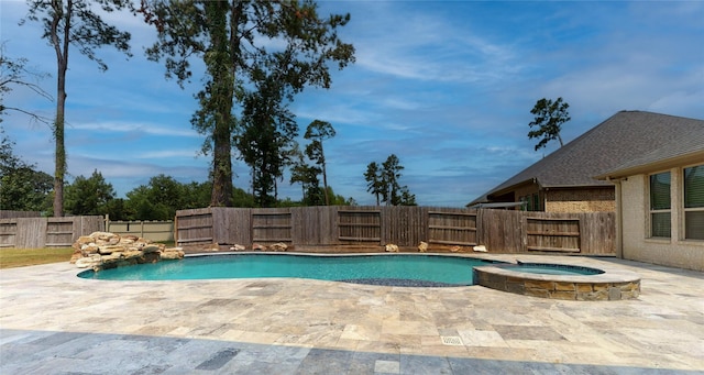 view of swimming pool featuring an in ground hot tub and a patio