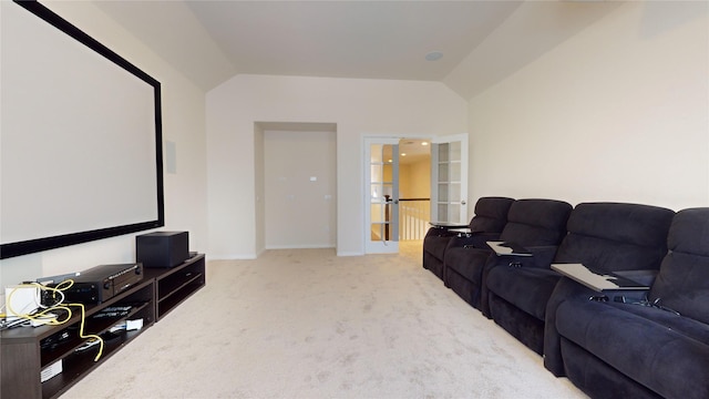 carpeted home theater room featuring lofted ceiling