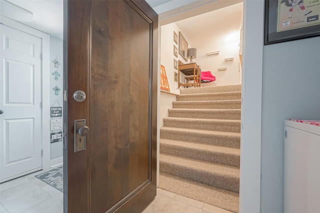 interior space with tile patterned floors and a textured ceiling