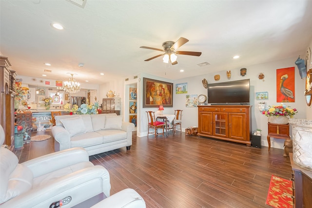 living room with dark hardwood / wood-style floors and ceiling fan with notable chandelier