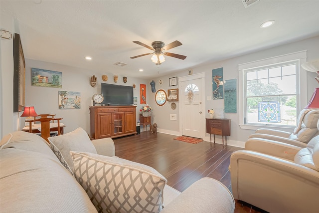 living room with ceiling fan and dark wood-type flooring