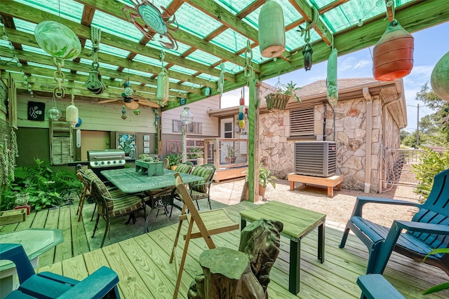 wooden deck featuring ceiling fan, cooling unit, and a grill