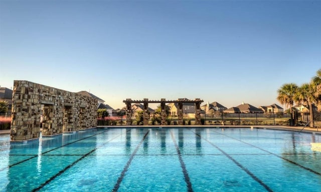 view of pool at dusk