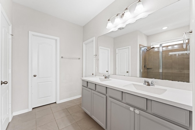 bathroom with tile patterned floors, a shower with door, and vanity