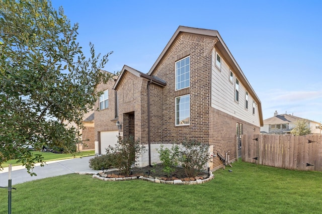 view of home's exterior featuring a lawn and a garage