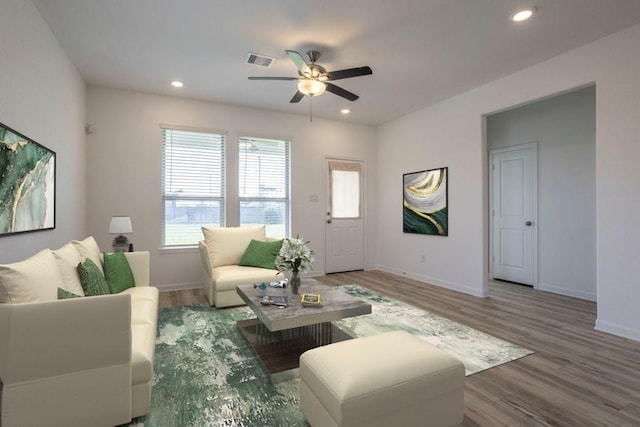 living room with ceiling fan and wood-type flooring