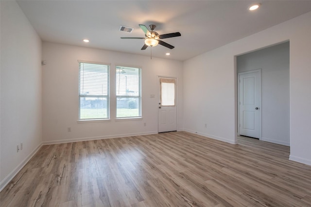 spare room with ceiling fan and light wood-type flooring