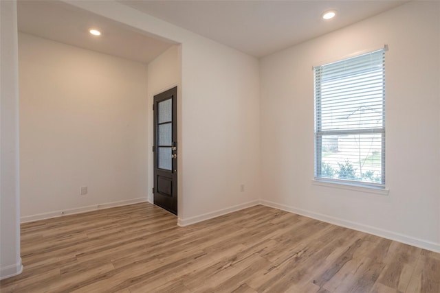 unfurnished room with light hardwood / wood-style flooring