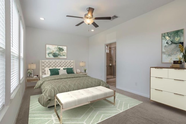 carpeted bedroom with multiple windows, ensuite bathroom, and ceiling fan