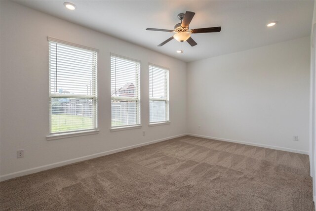 carpeted empty room featuring ceiling fan