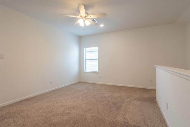 carpeted spare room with ceiling fan