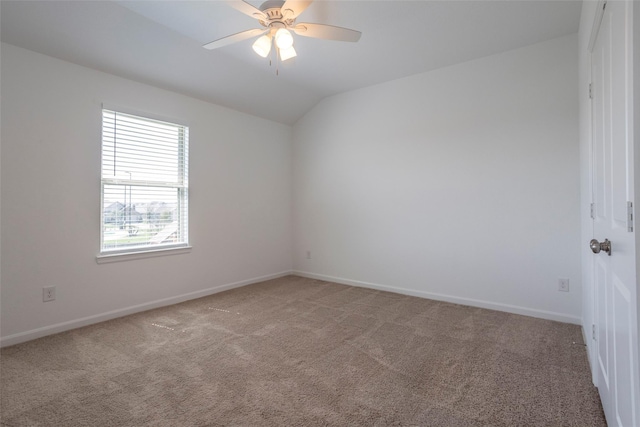 carpeted empty room featuring ceiling fan and lofted ceiling