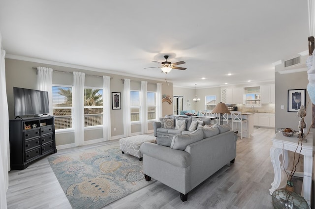 living room with ceiling fan, light hardwood / wood-style flooring, sink, and ornamental molding