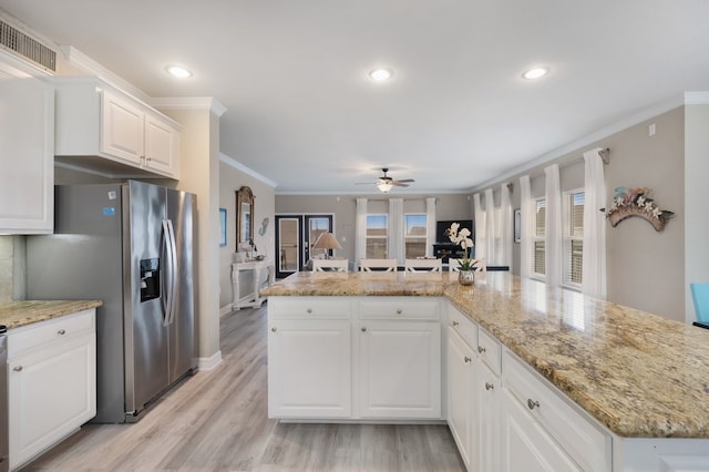 kitchen featuring white cabinetry, french doors, light stone counters, and ornamental molding