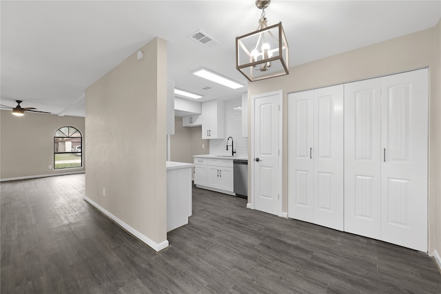 hall with dark hardwood / wood-style flooring, sink, and an inviting chandelier