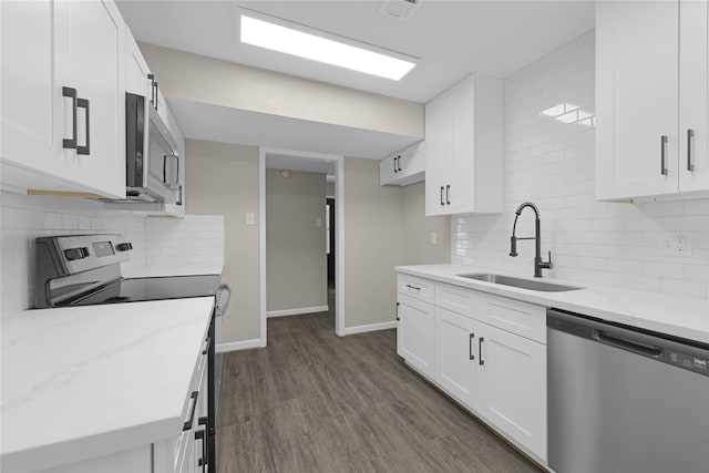 kitchen featuring dark hardwood / wood-style floors, white cabinetry, and stainless steel appliances