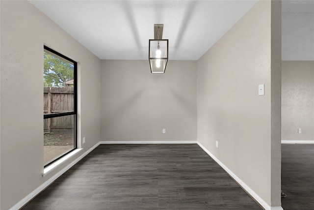 unfurnished dining area featuring dark wood-type flooring