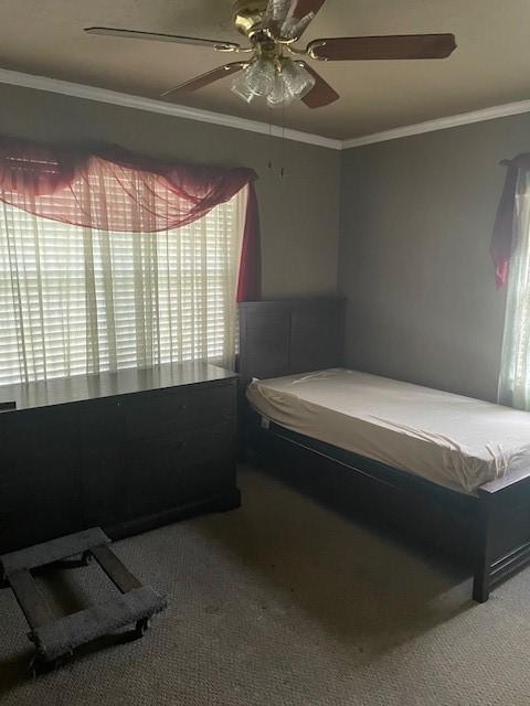 carpeted bedroom with ceiling fan, crown molding, and billiards